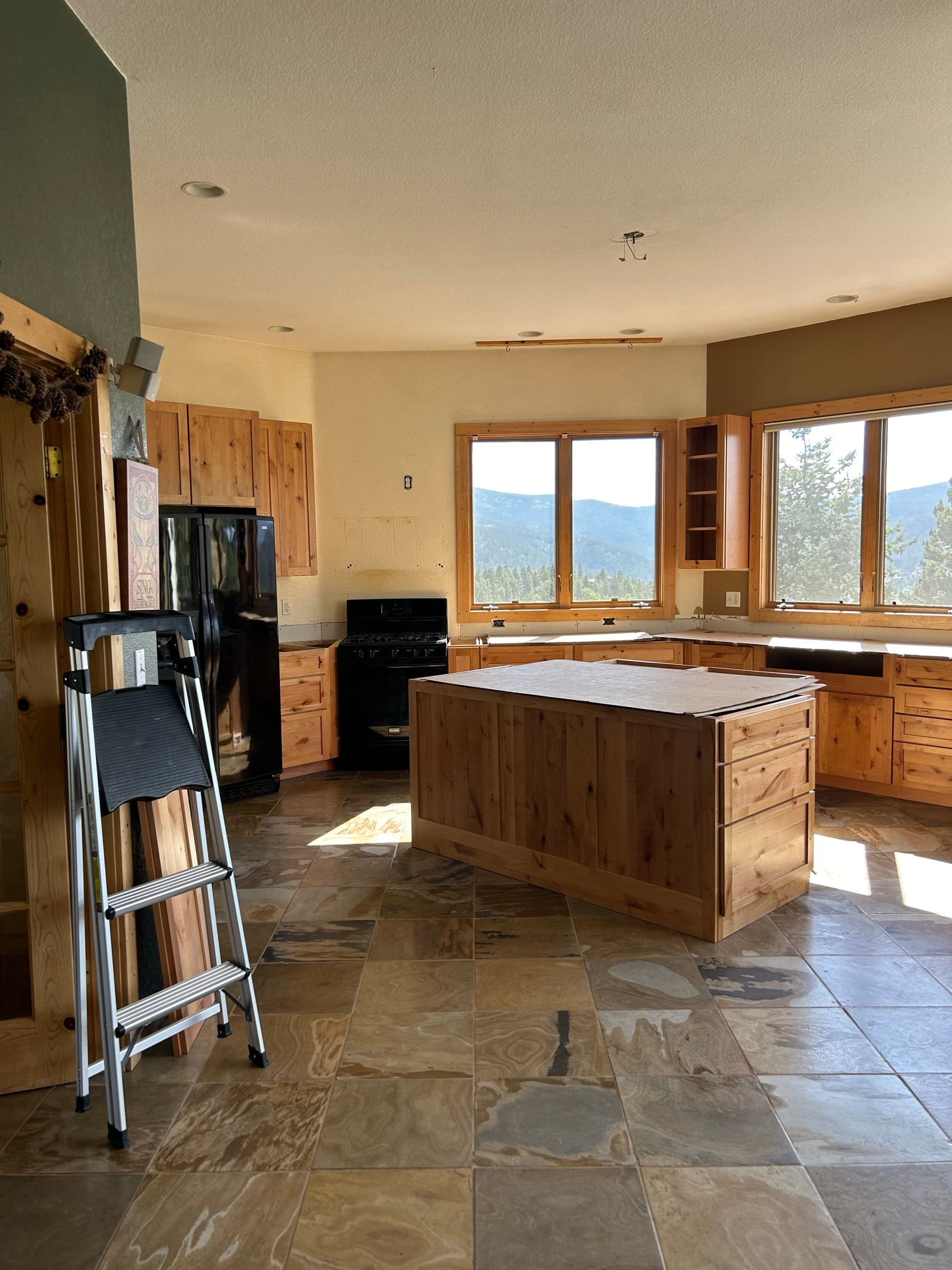 Open kitchen layout with pine island and mountain views through the windows