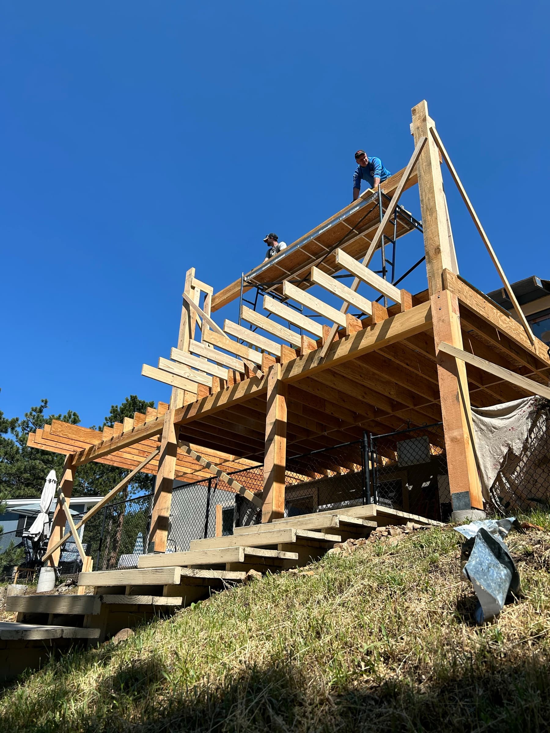 Heavy timber deck framing on a hillside