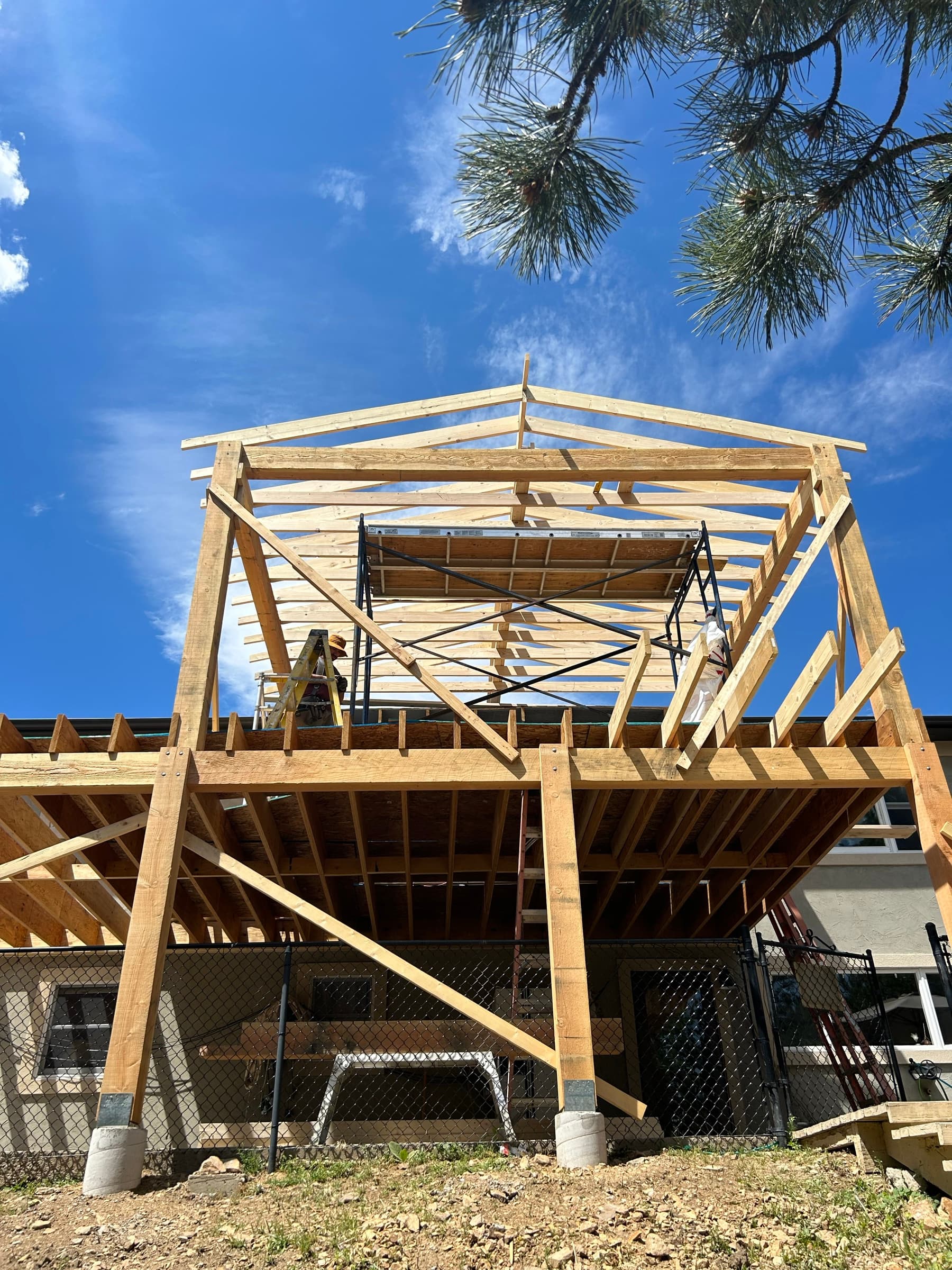Two-level timber deck structure with a gabled upper roof