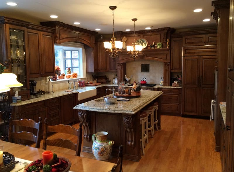 Kitchen with warm wood tones, crown molding, and granite counters
