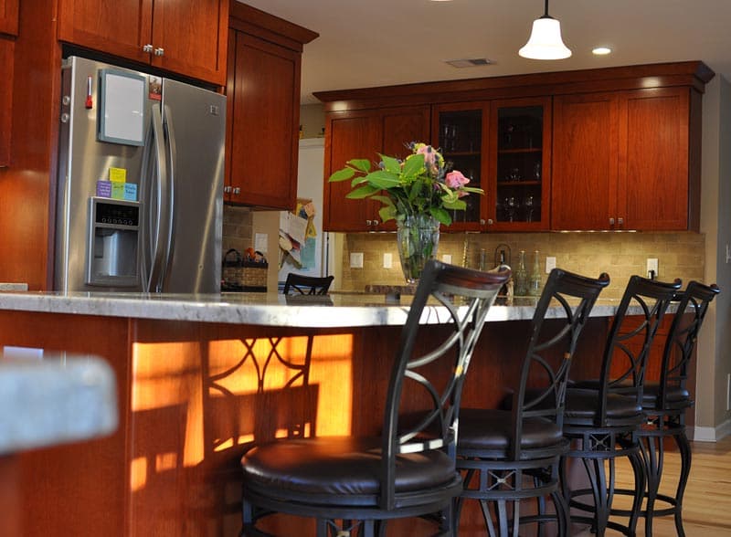 Finished kitchen addition with island, dining table, and French doors to the yard
