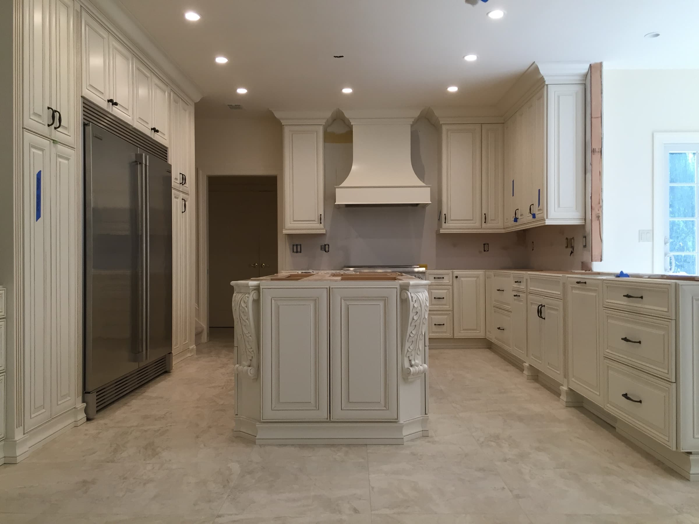 White custom cabinets and island during installation
