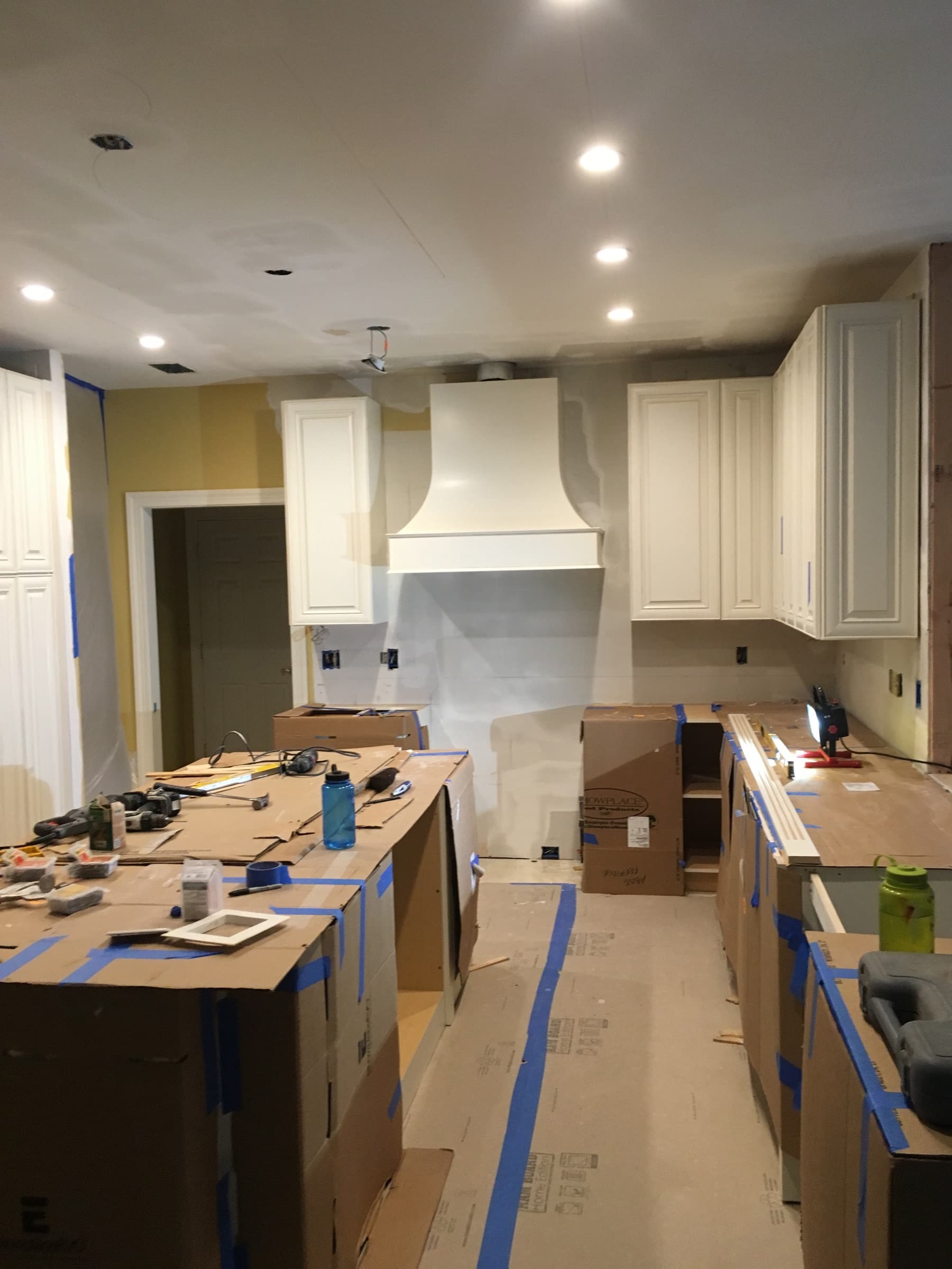 Kitchen remodel in progress with floor protection down